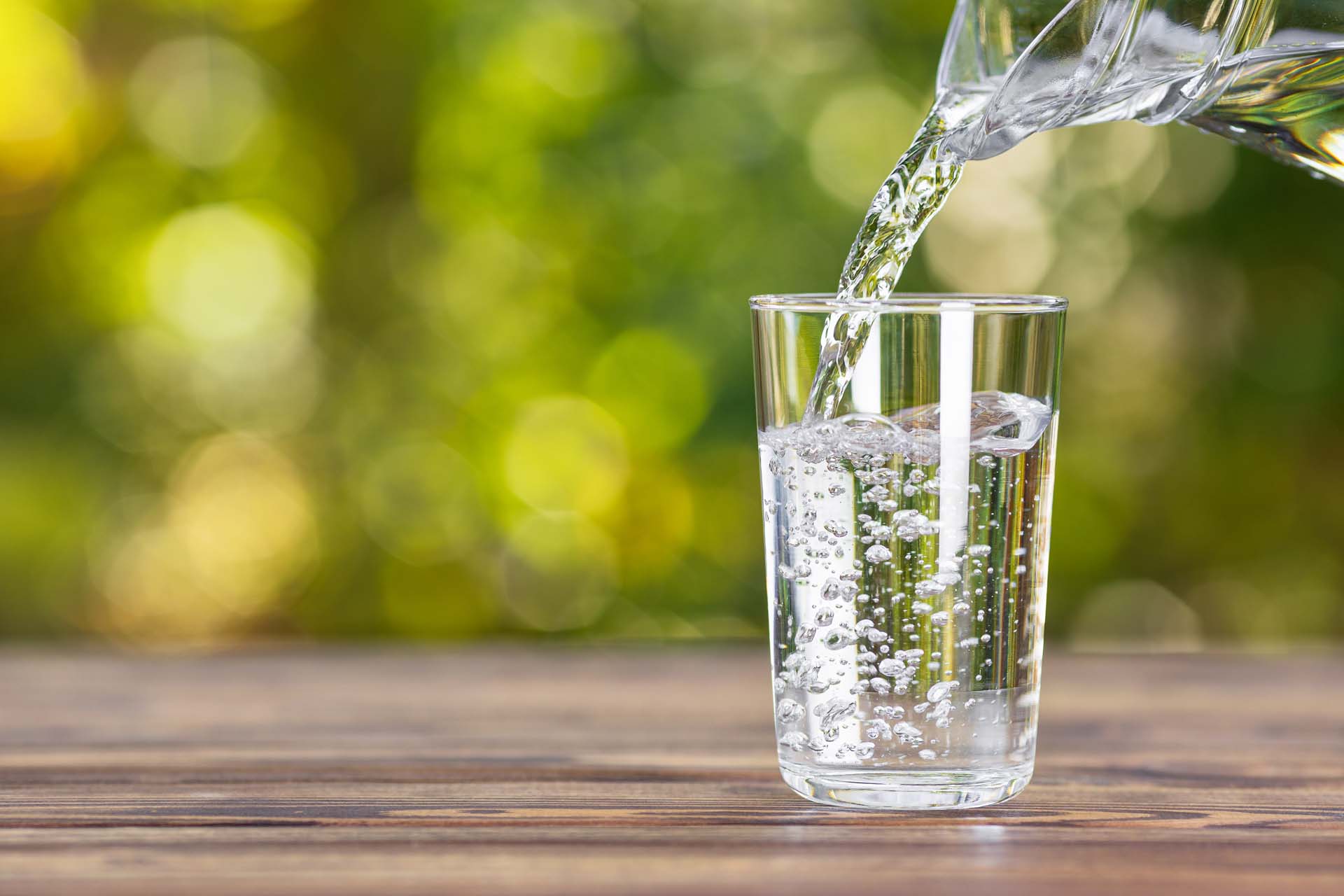 Water being poured from a jug into a glass