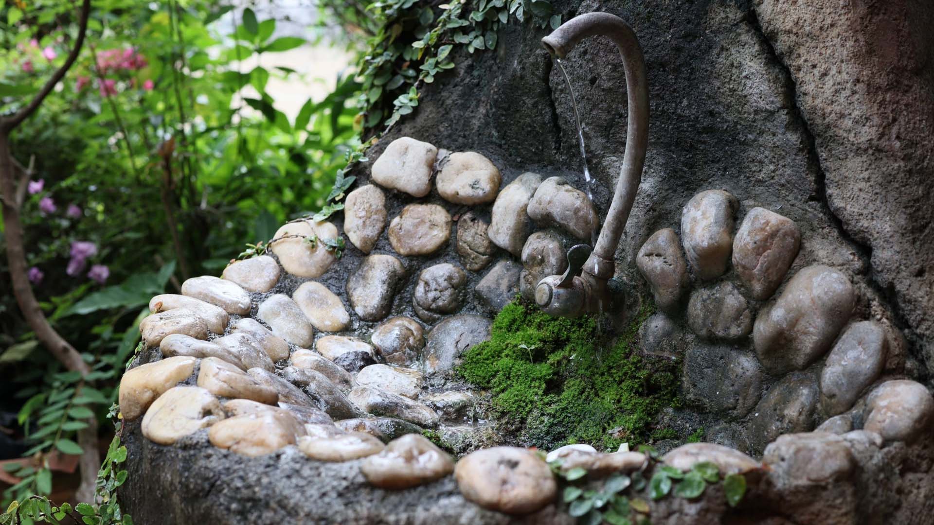 An outdoor sink made from natural looking stones