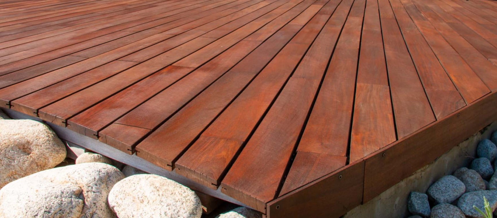 A close up of wooden decking in a garden | Shutterstock
