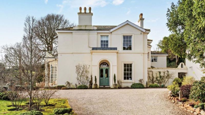 beautiful big white house with an eggshell door