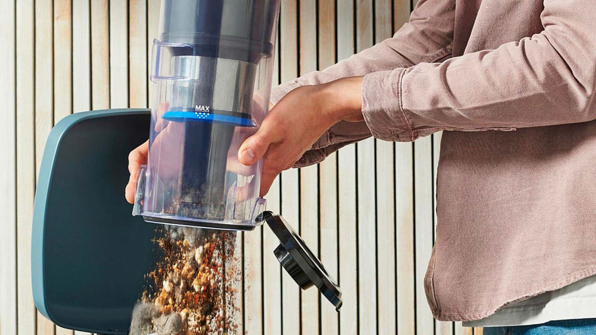 Emptying the Dyson vacuum into the bin