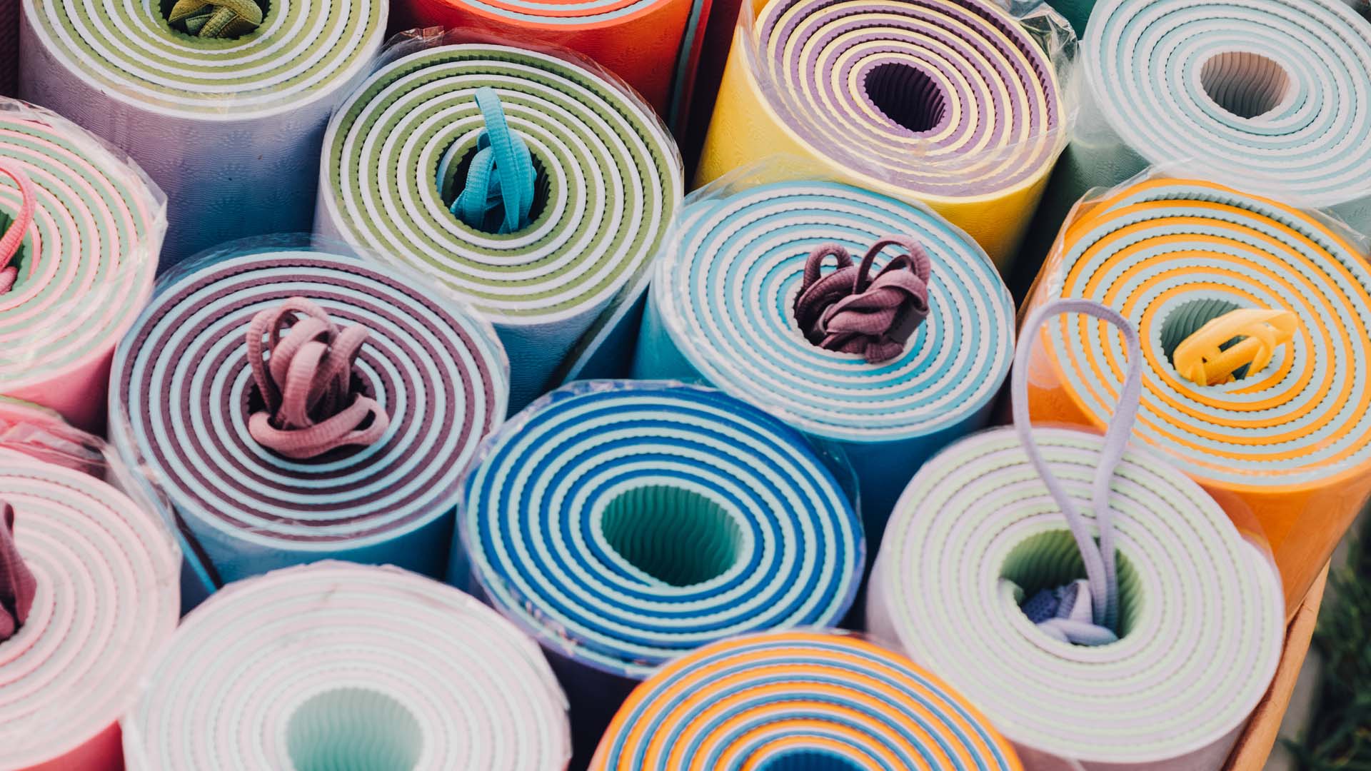 A few colourful folded yoga mats lined up