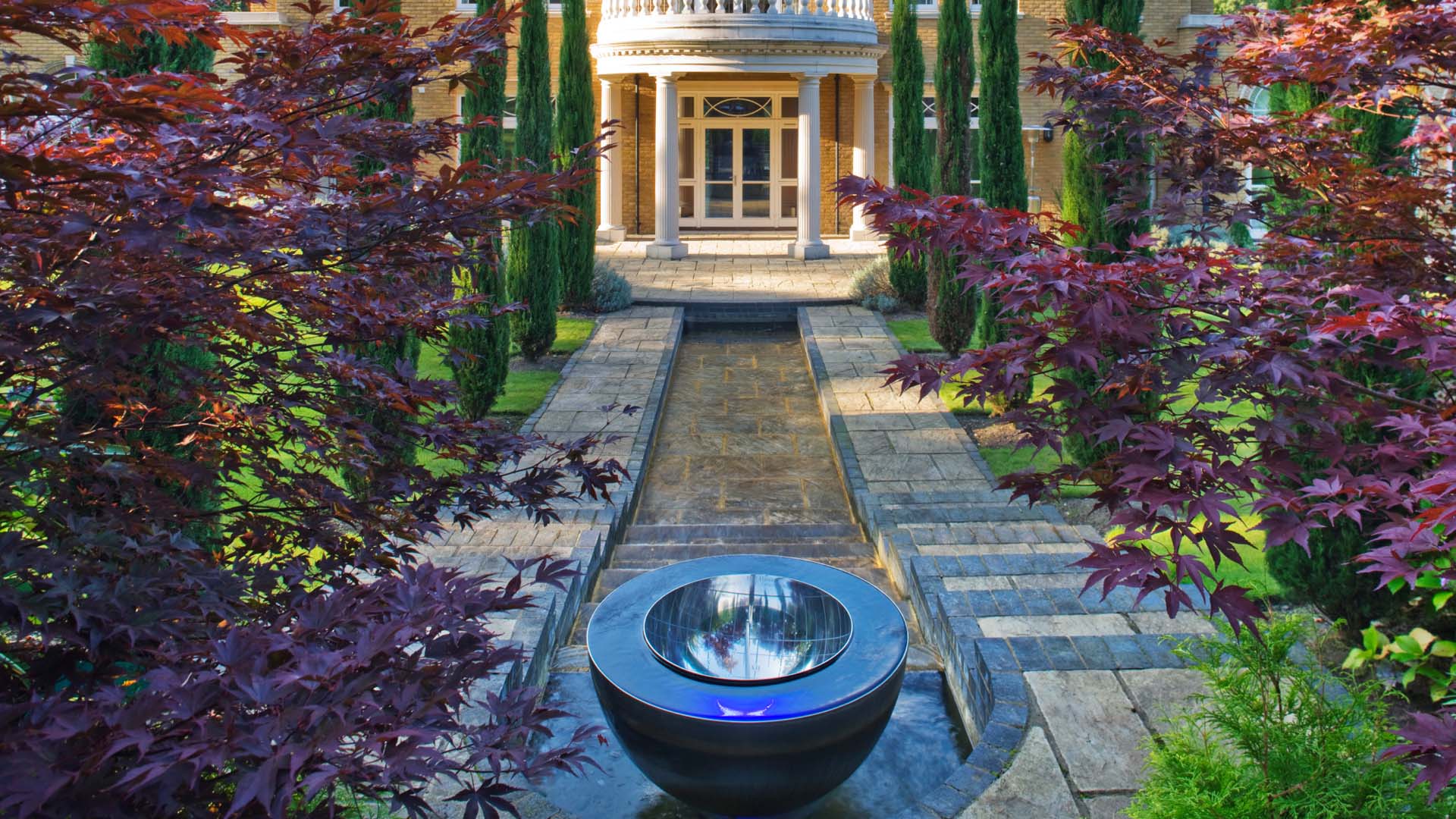 A reflective sculpture in a long garden