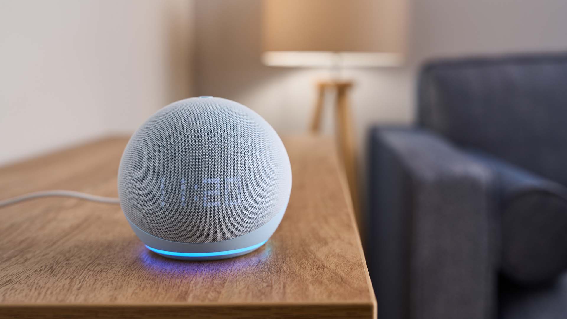 Close-up of an Amazon Echo Dot device on a side table in a living room