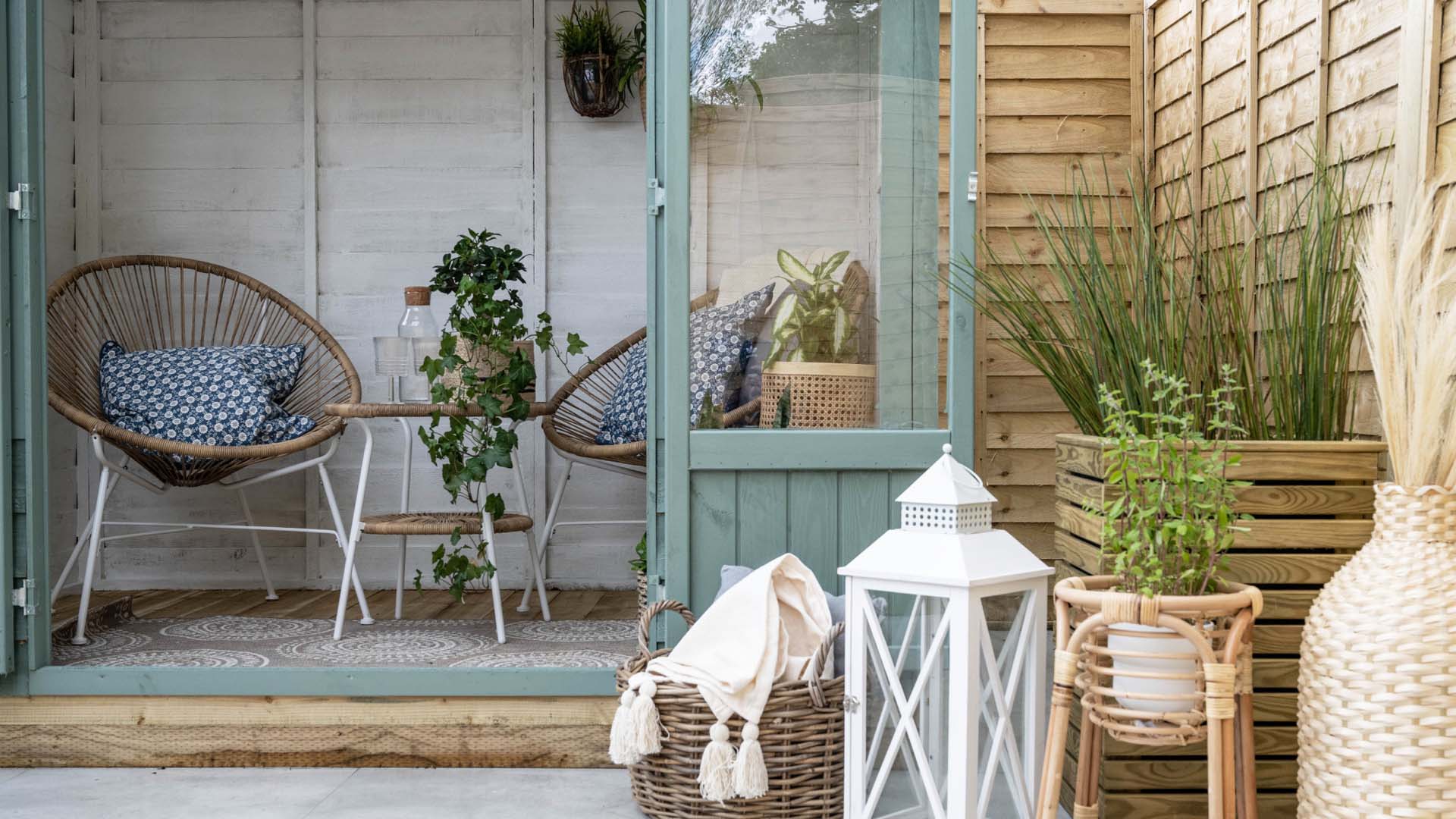 Garden shed with glass doors, painted in light white and Bullrush-Green colours to make it look bigger
