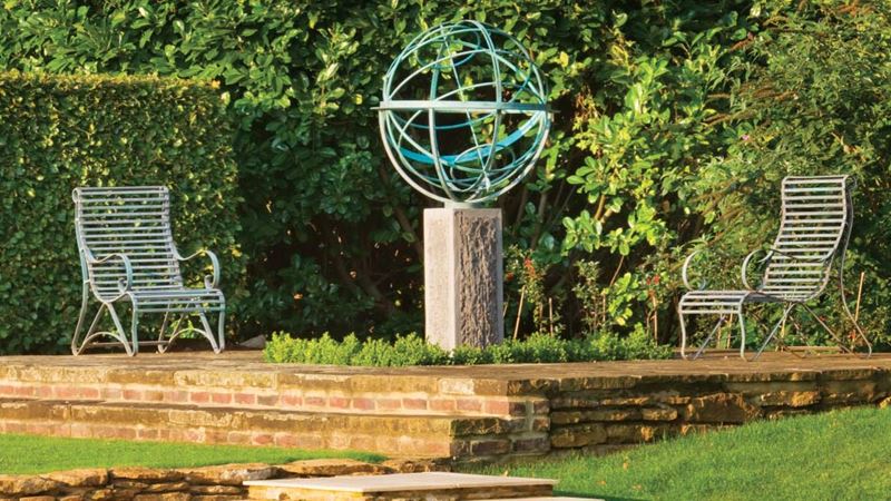 A tier of a garden featuring a large sculpture