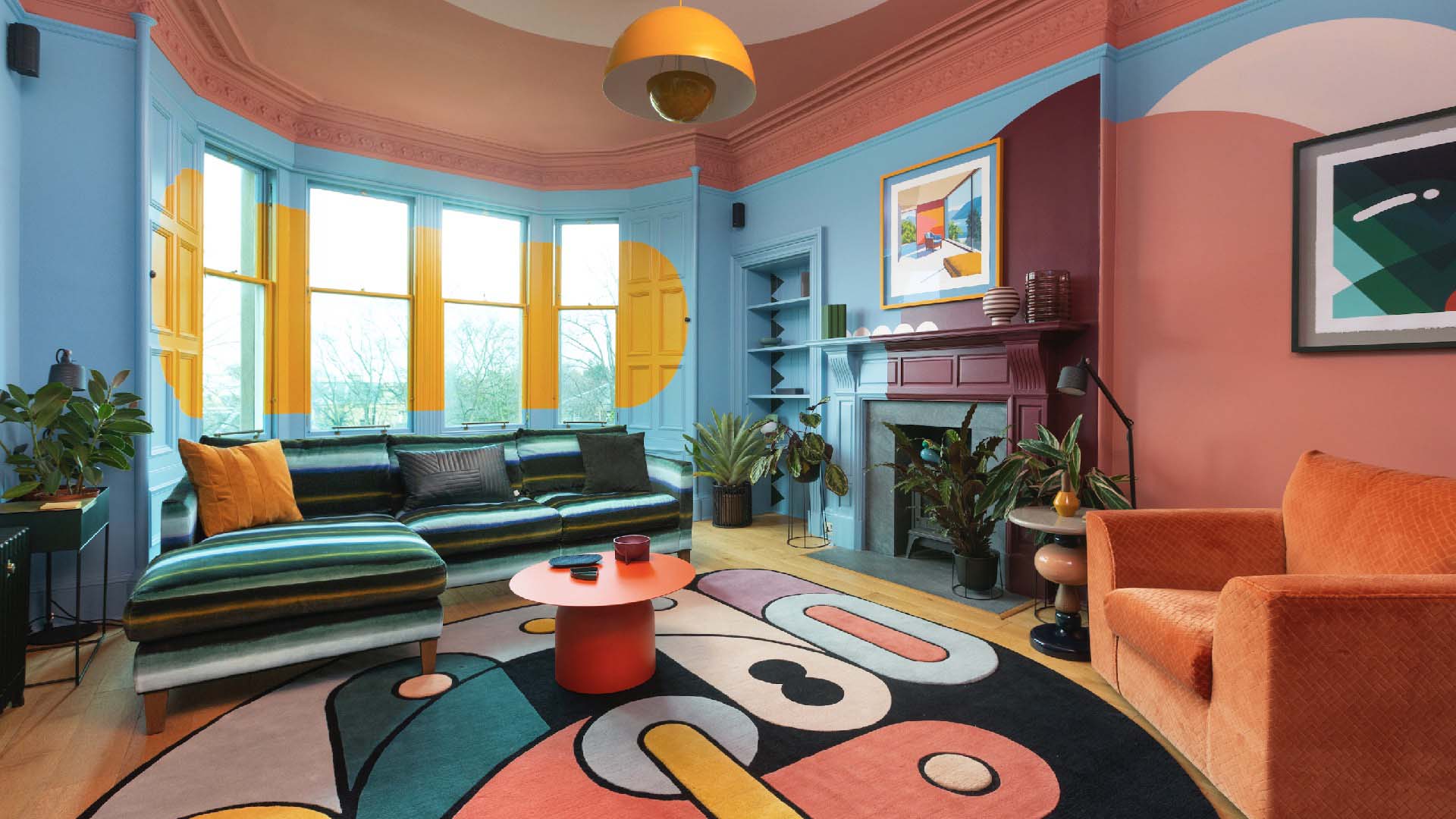 Brightly decorated room with soft shapes painted in bright colours such as yellow, blue and orange