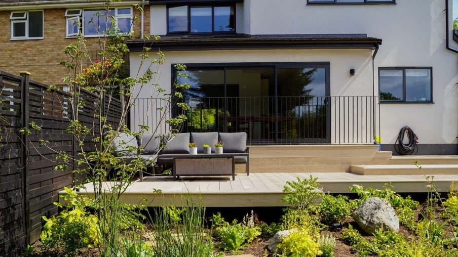 A patio area with seating on a garden tier