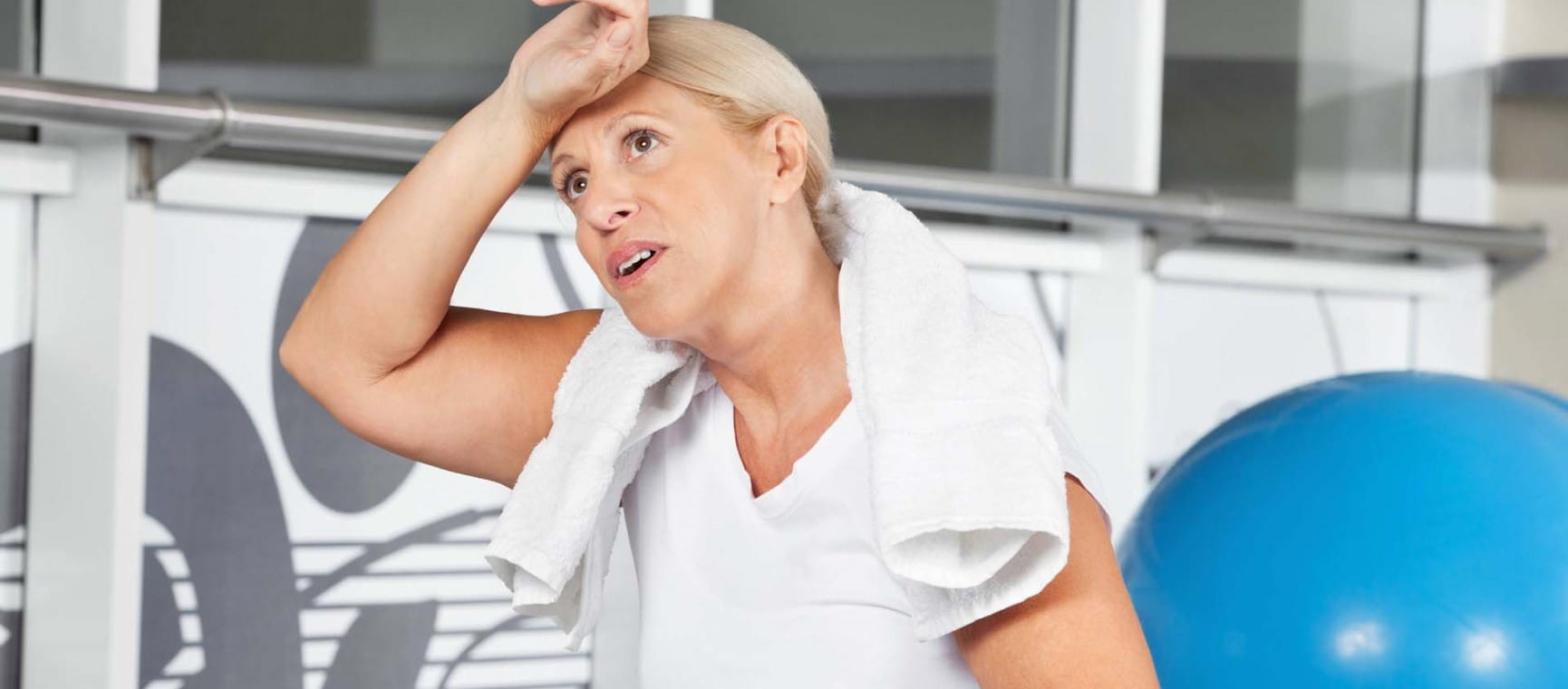 A woman looks hot after exercising in the heat | Shutterstock/Creative Family