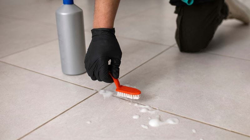 cleaning the grout on the floor