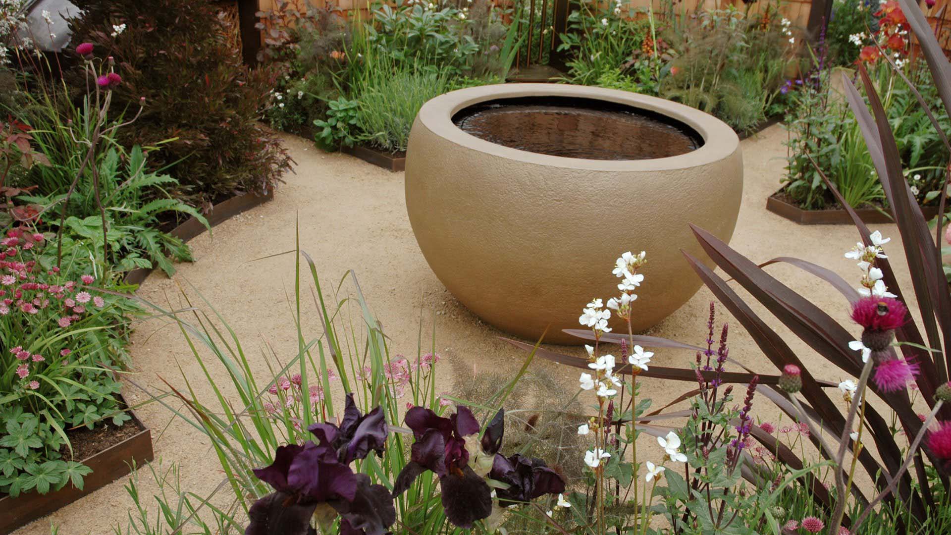 A self-binding gravel pathway around a large bowl-like central garden feature