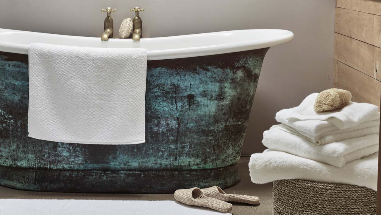 Bath towel on the side of a roll top bath
