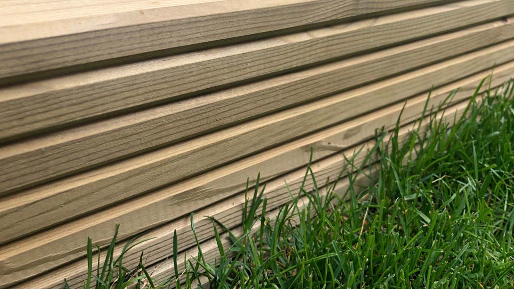 Close up of the wood deck side on the grass