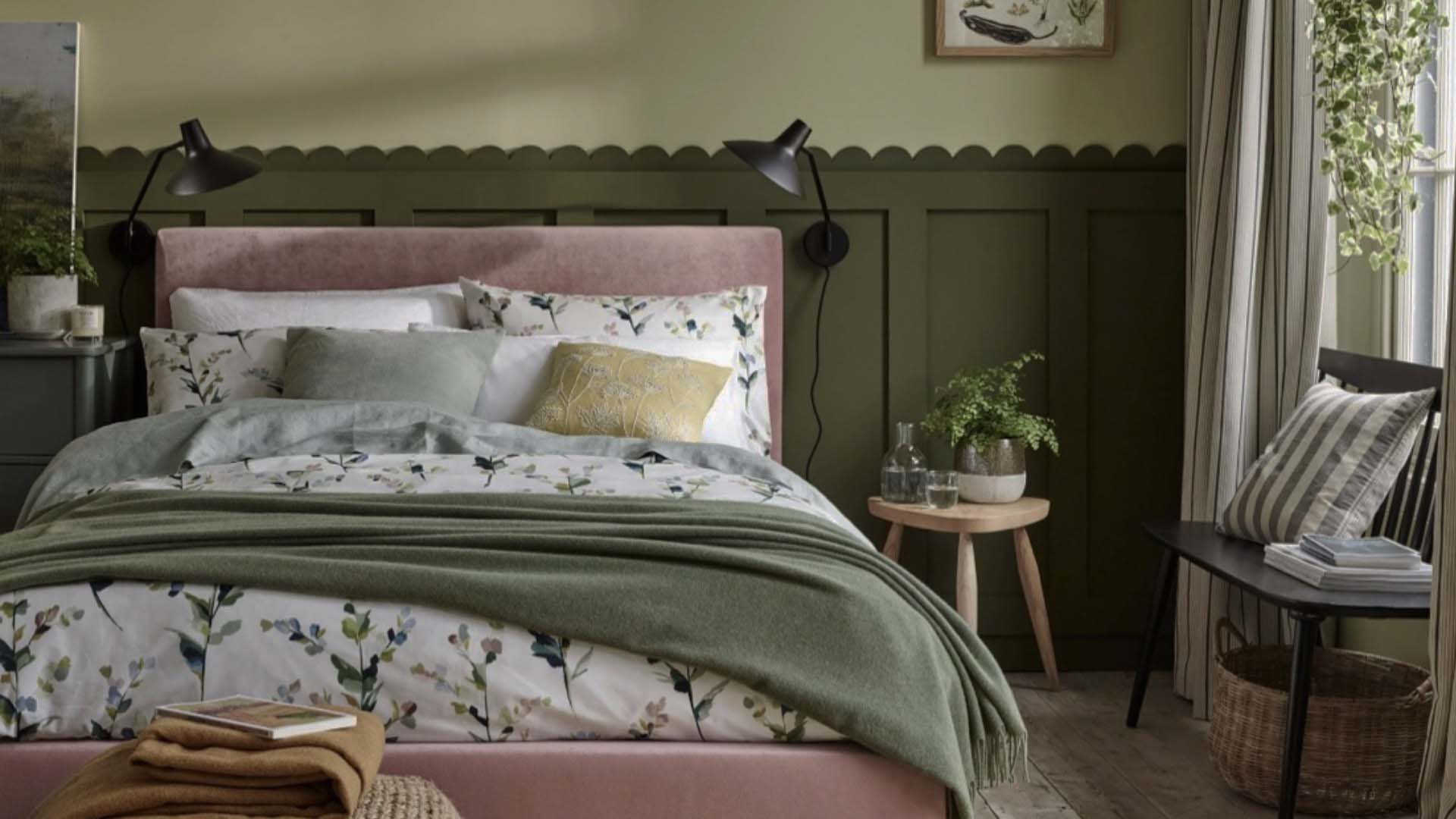 Green paneling and a pink bed