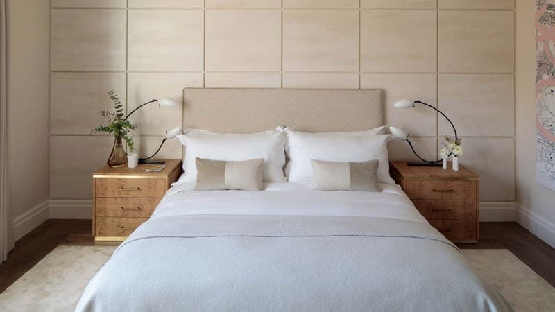 A small bedroom with jazzy bedside tables and lights for character