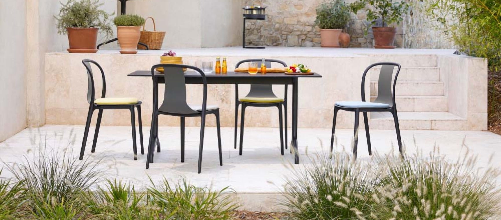  A seating area on a patio of creamy white stone | Nest.co.uk
