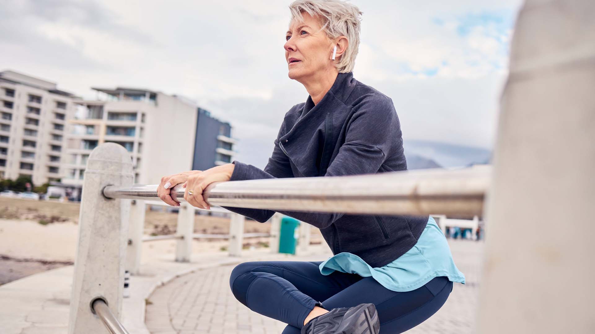 woman stretching using a gate