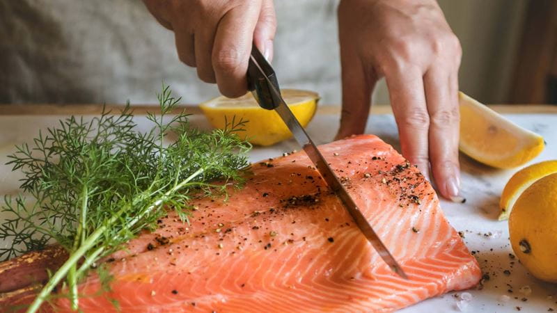 Salmon being sliced