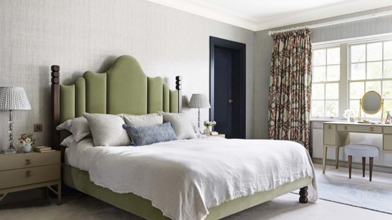 Bedroom with bed featuring green headboard