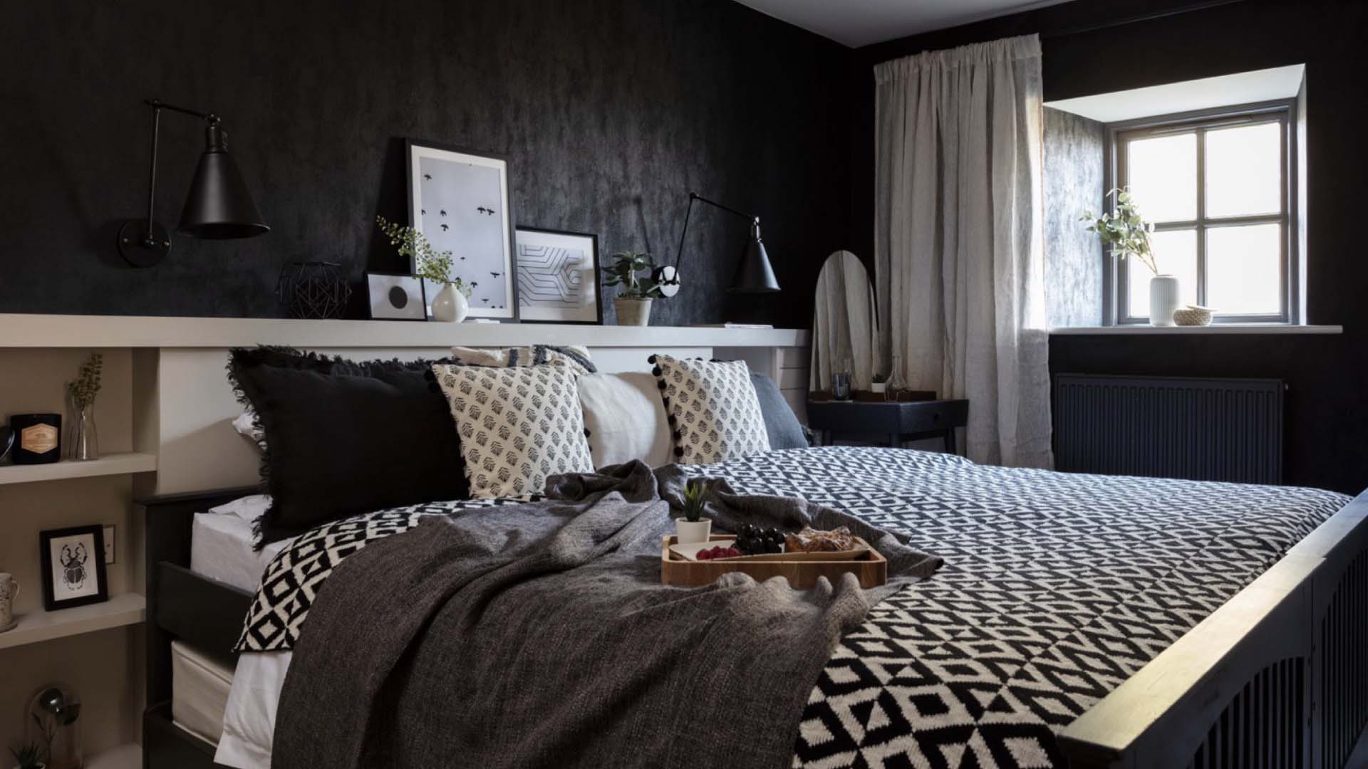 a dark bedroom with white highlights to brighten it up