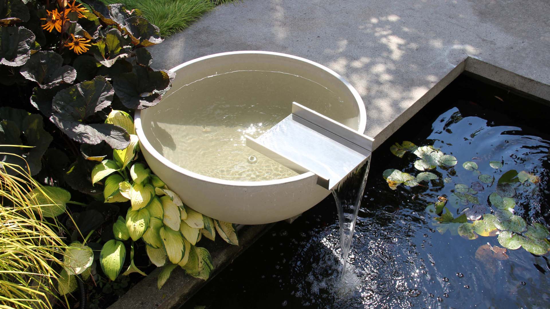 A trickling water feature shaped like a bowl