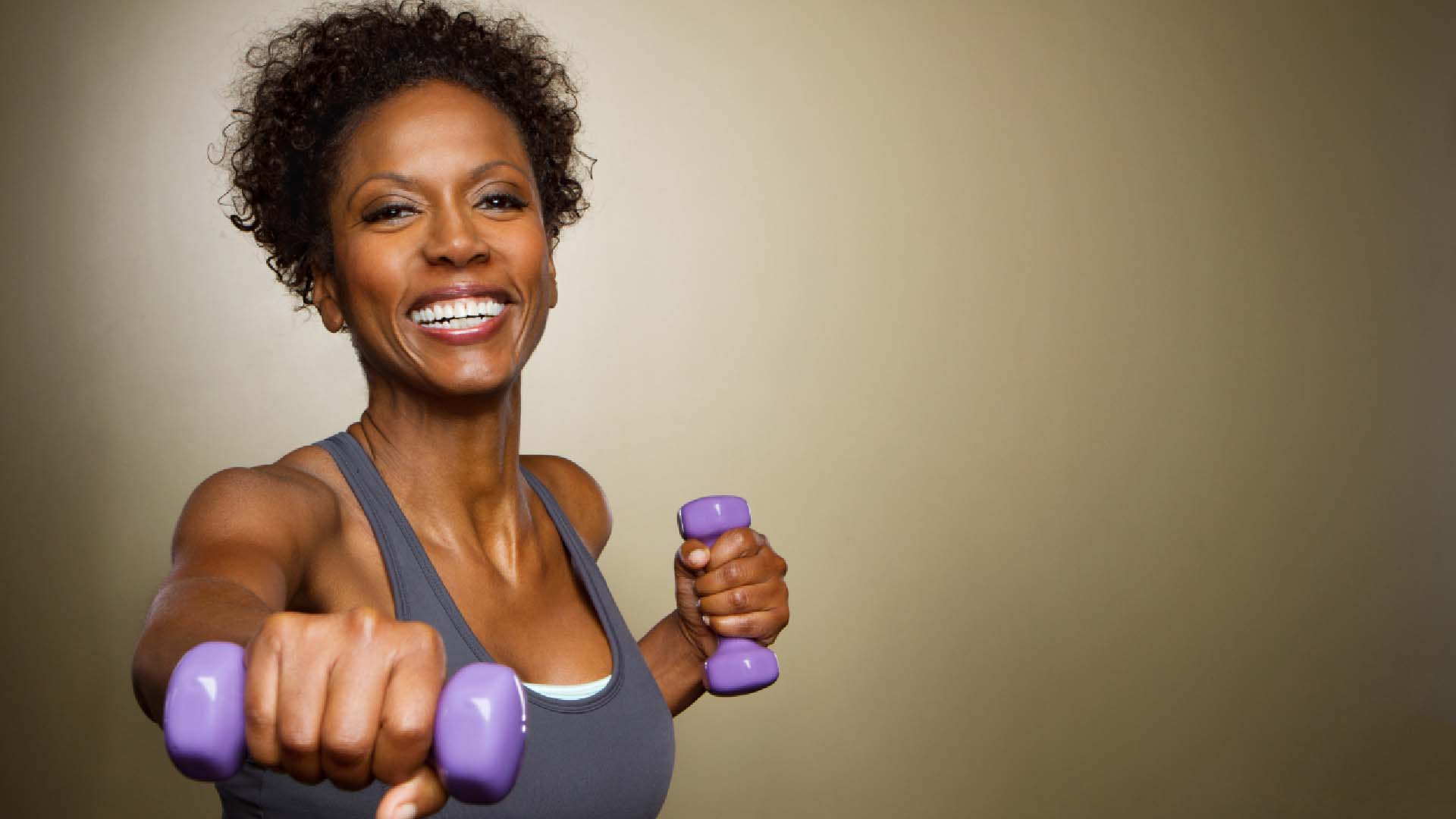 Woman holding weights up to the camera