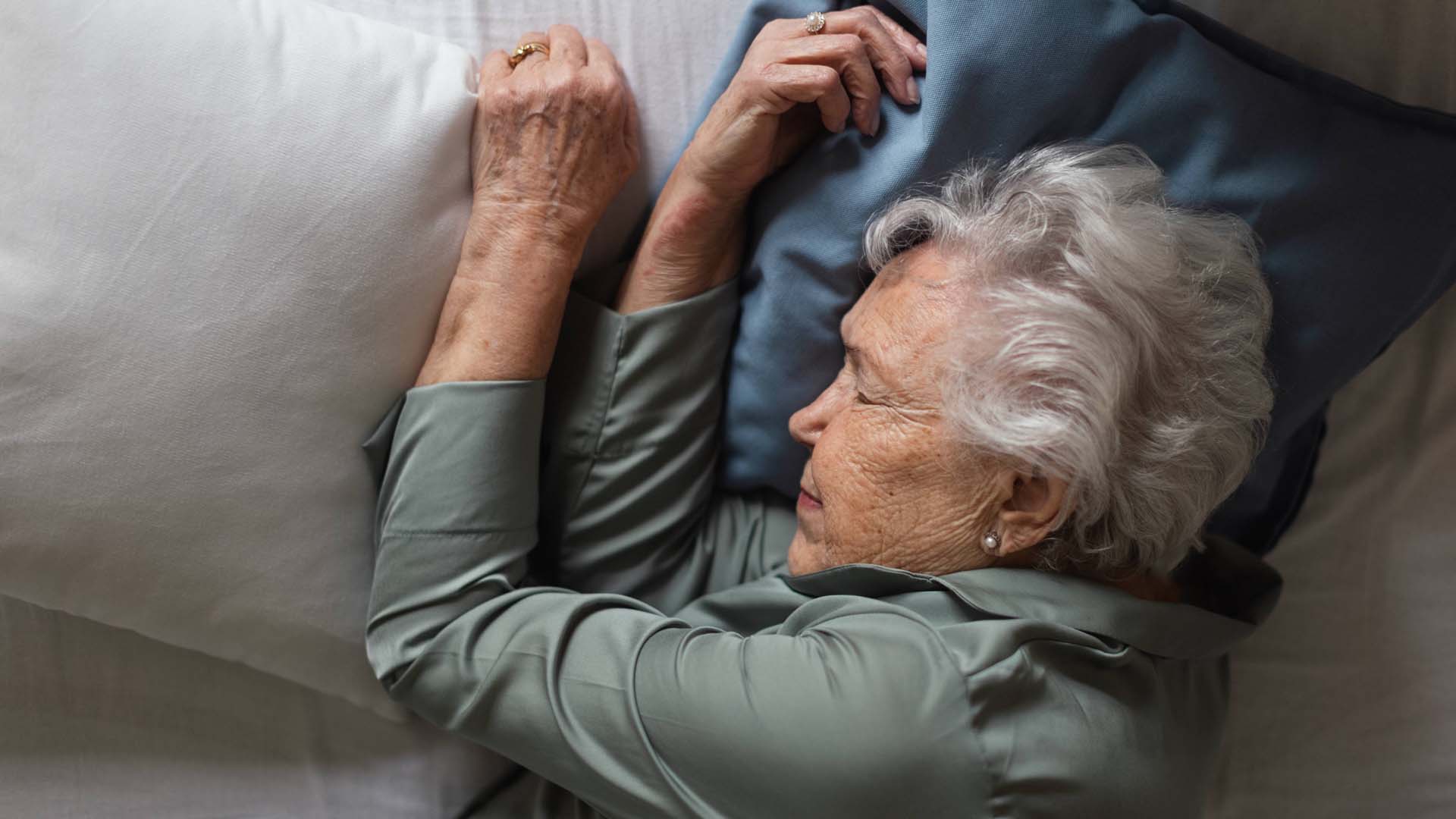 An older lady sleeping in bed