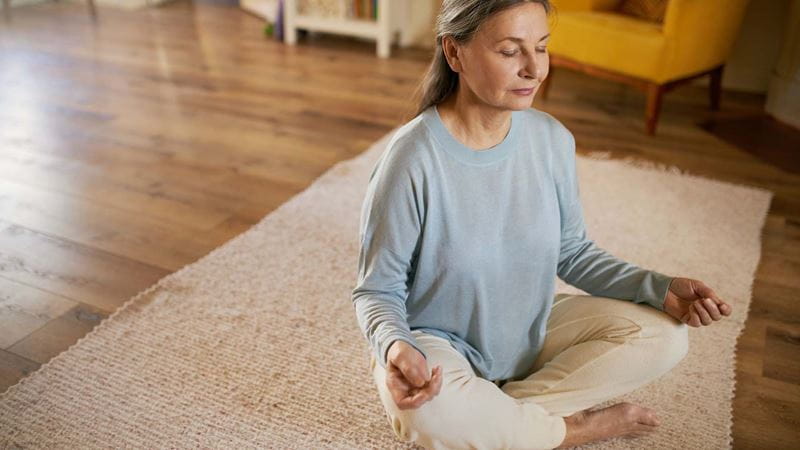 A lady meditating in her lounge