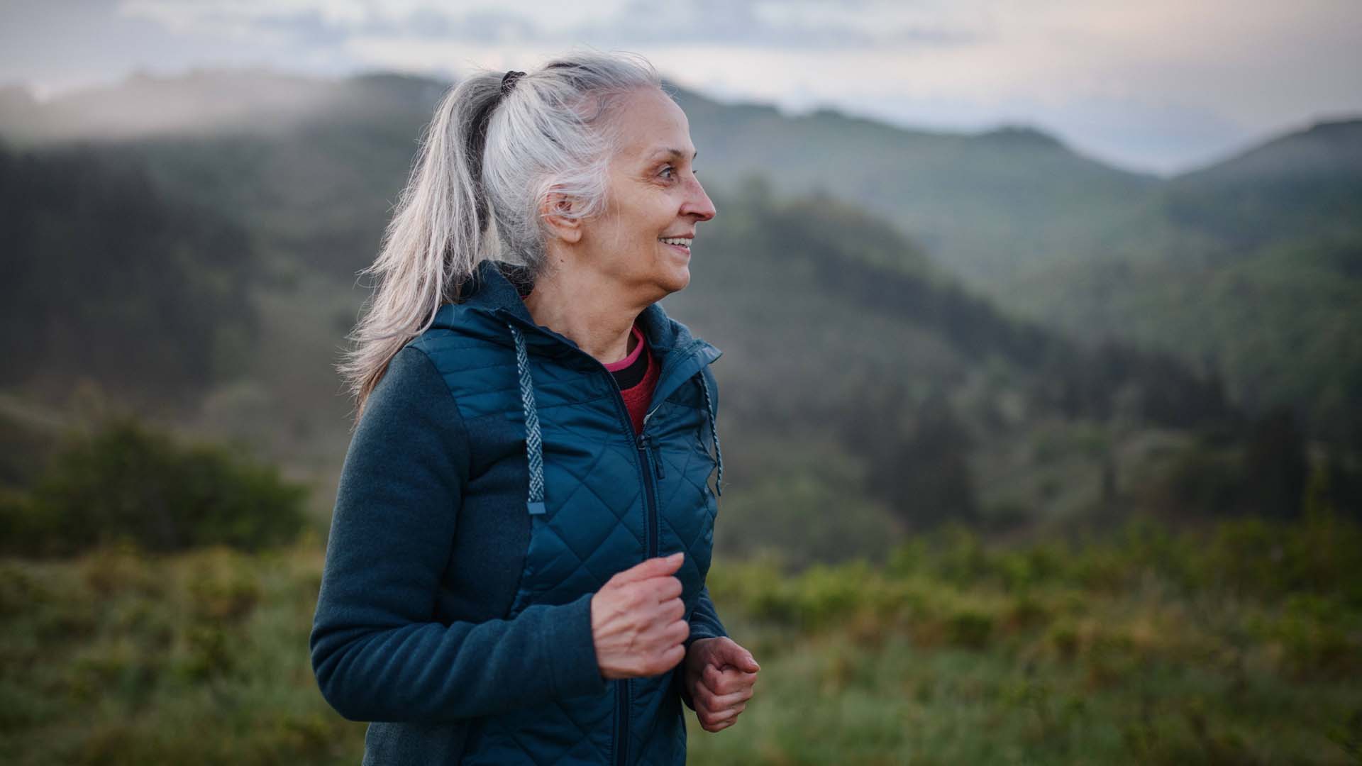 Senior beginner trail runner in the mountains 