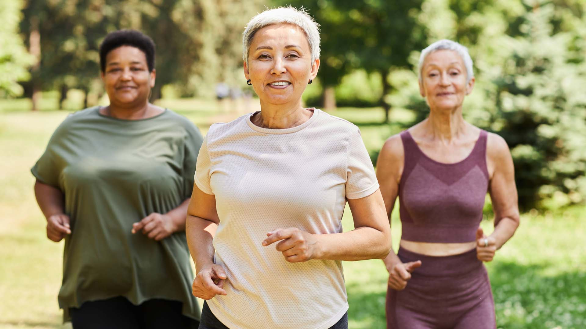 Group of women running outside with proper running form