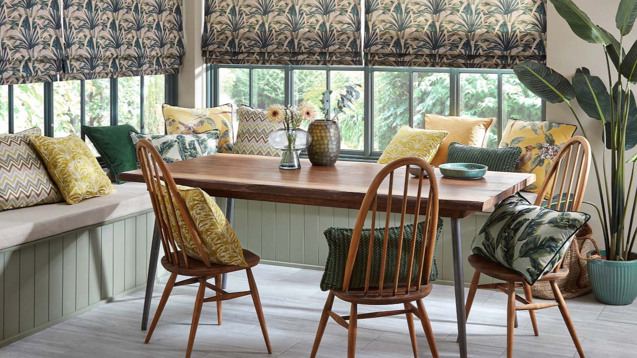 banquette in a conservatory with blinds at the window