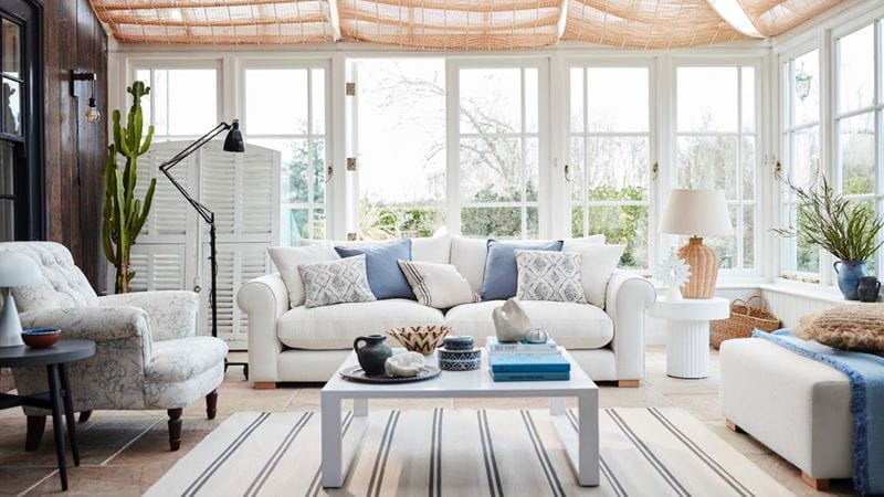 large light conservatory with white sofas