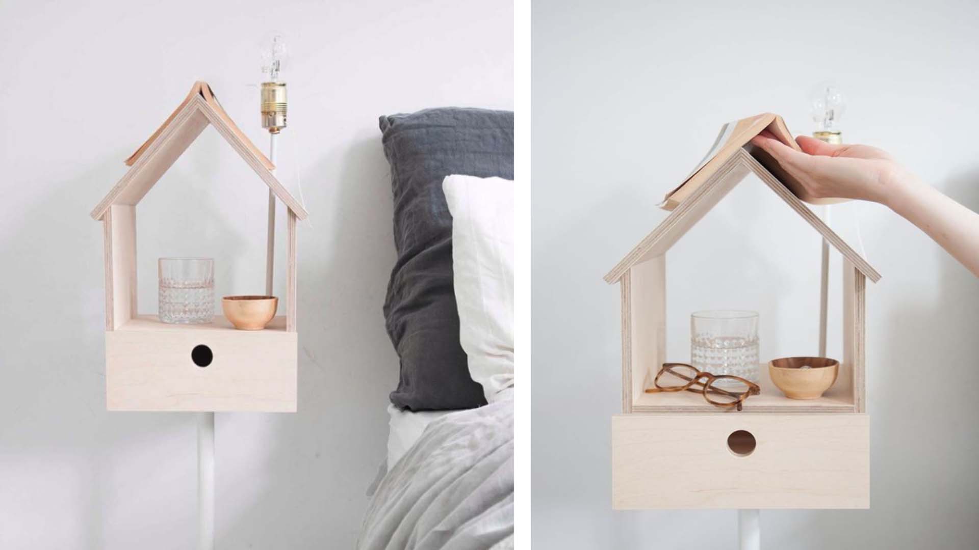 A birdbox used as a bedside table with a book propped open on the roof