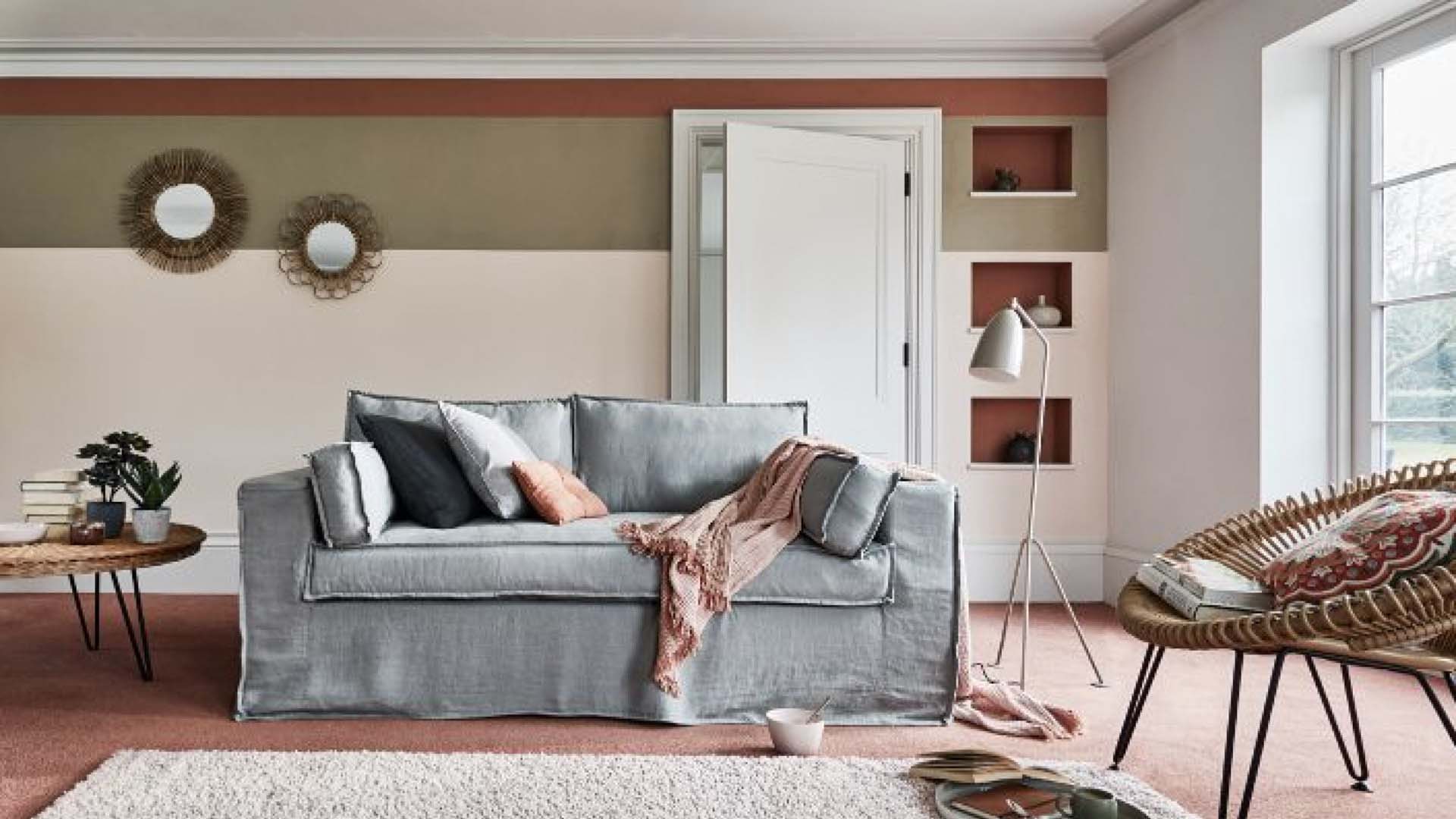 A large cream rug on red flooring