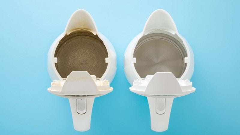 Two kettles showing the inside; one is clean and one is scaly