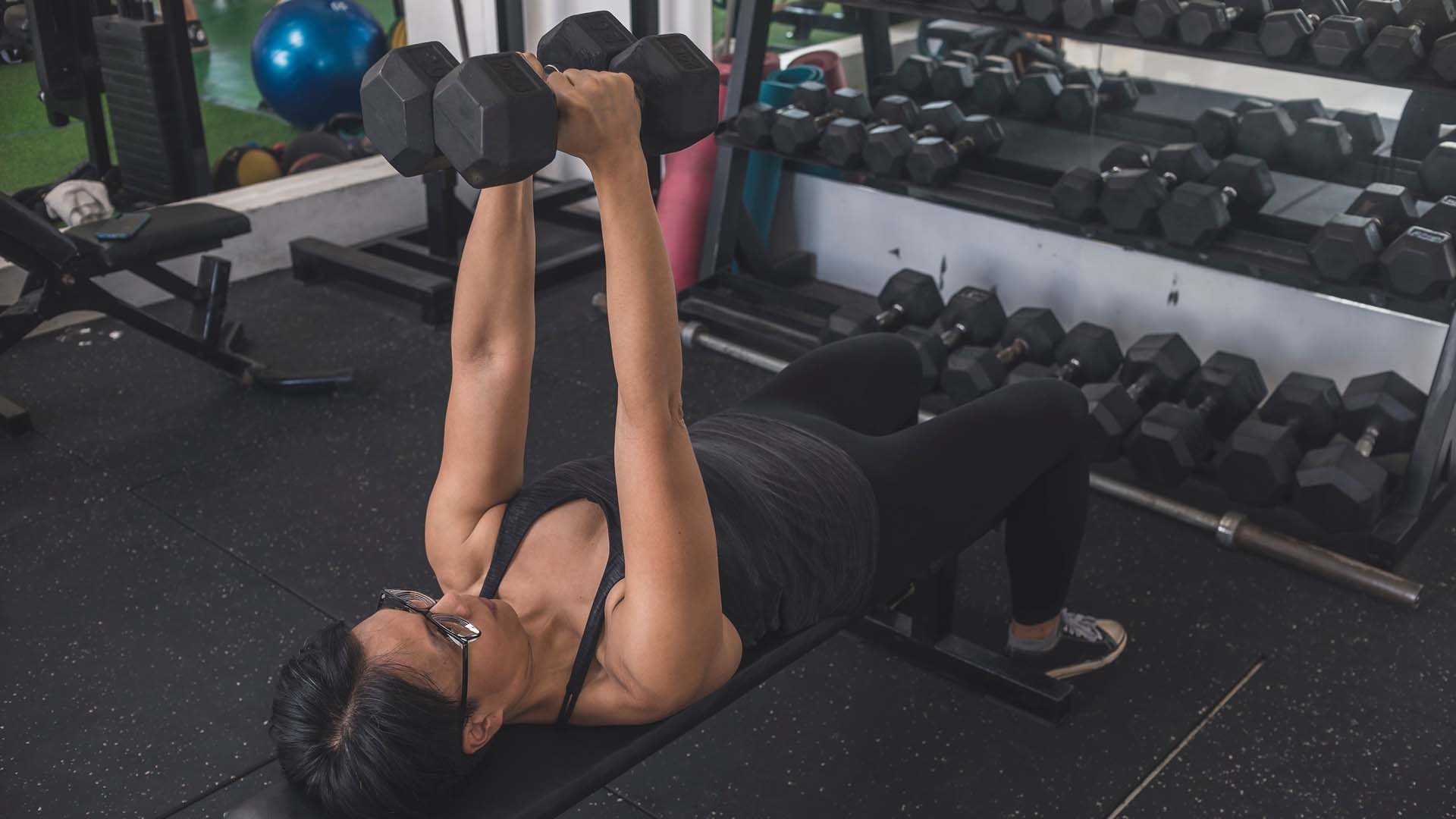 woman doing a dumbbell press