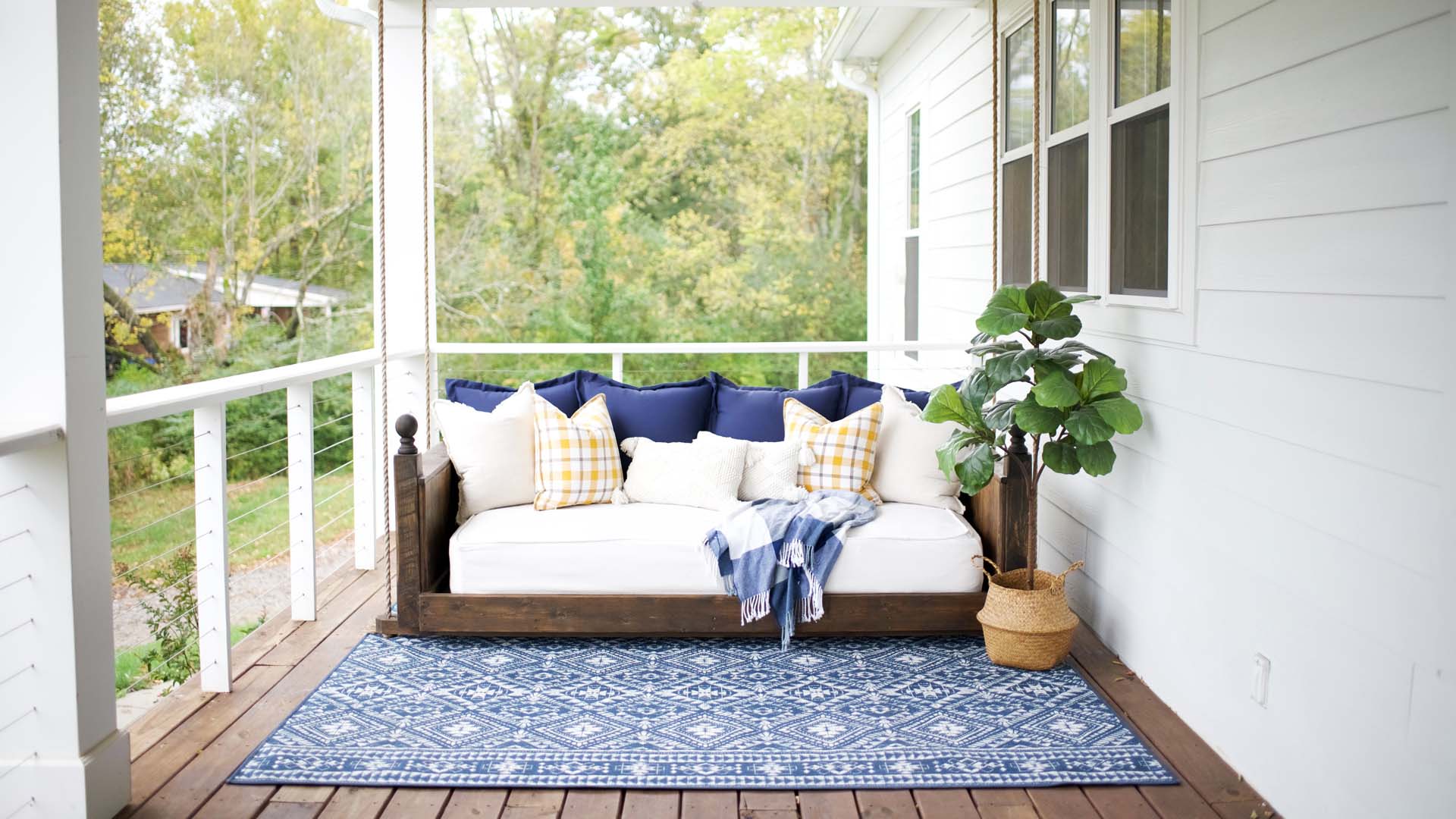 A rug and sofa on an outside verandah