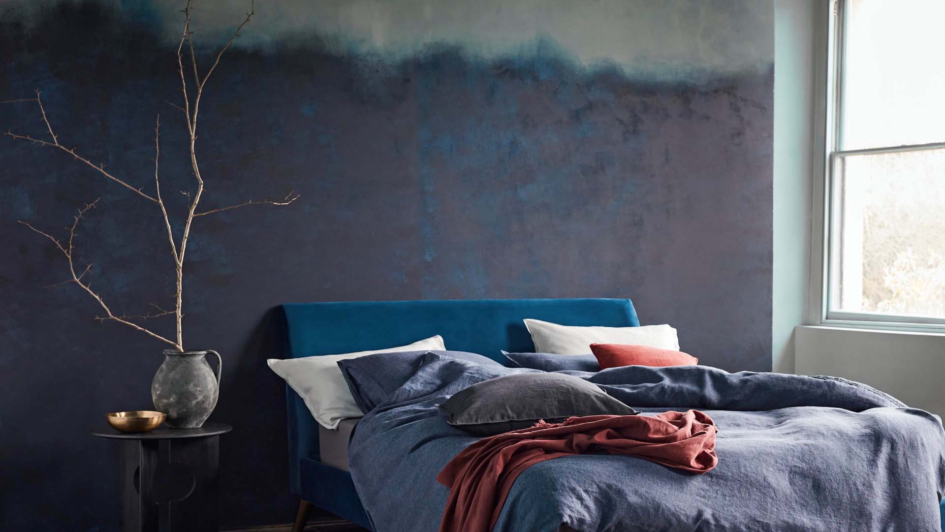 Restful looking bedroom with dark colours