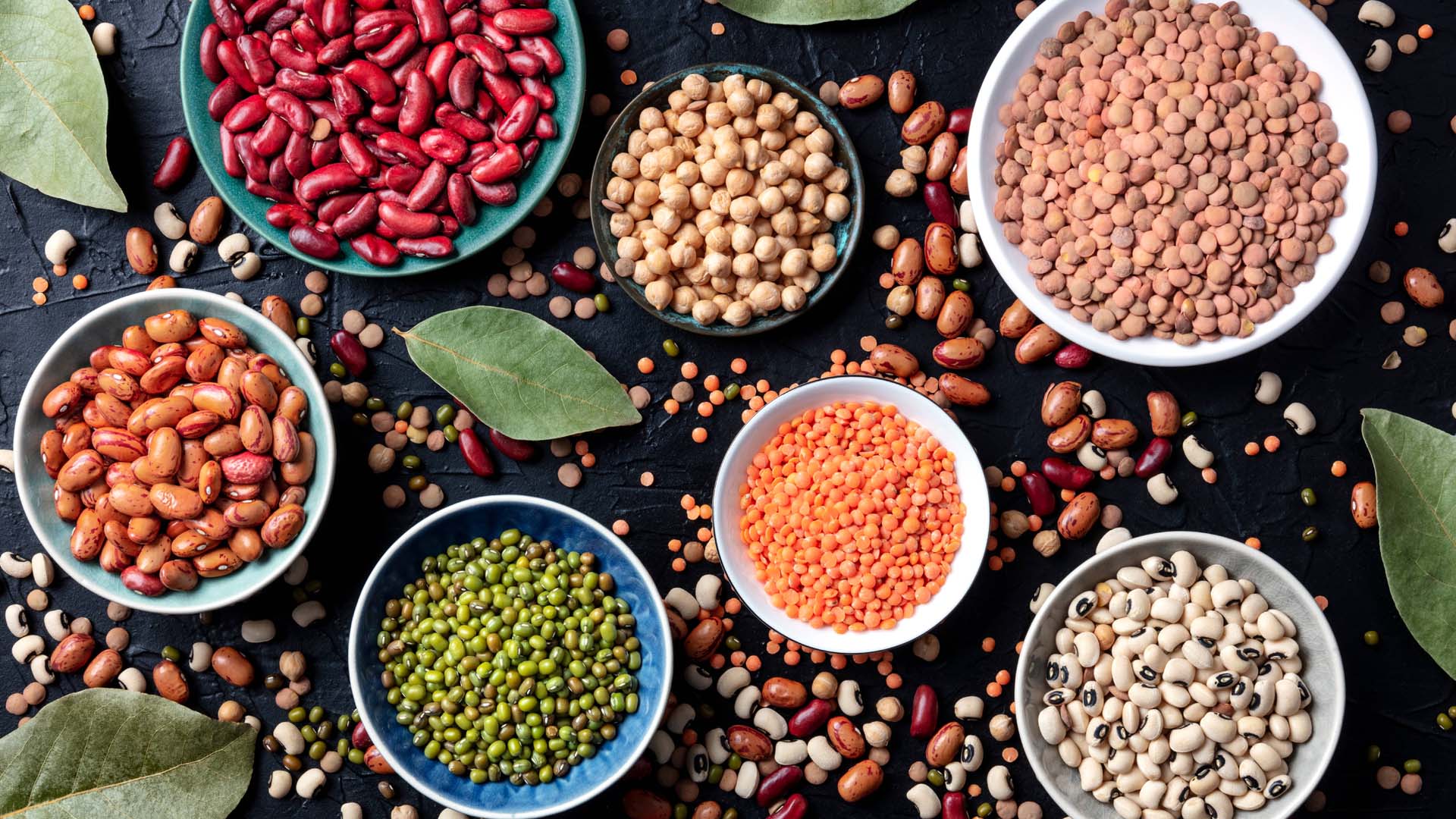 7 different types of colourful legumes in bowls