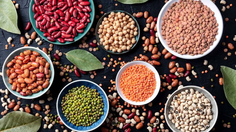 7 different types of colourful legumes in bowls