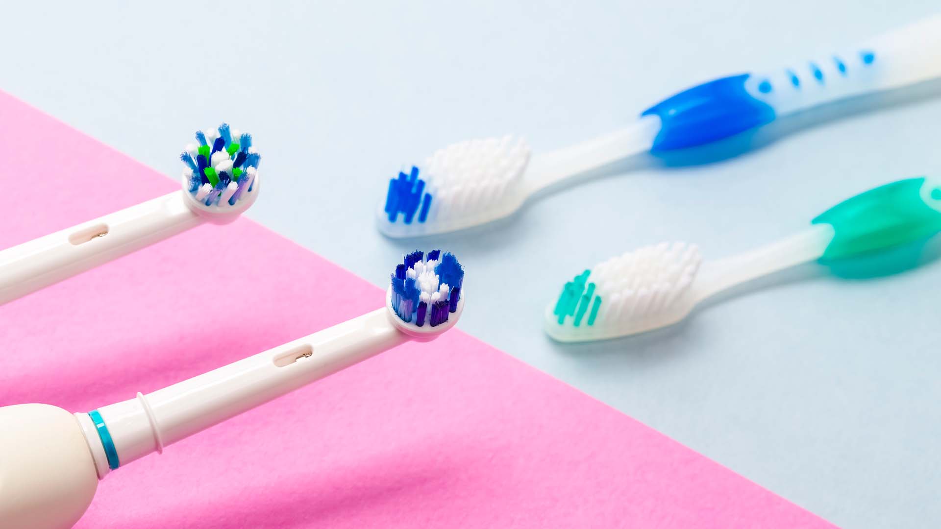 Electric and manual toothbrushes side by side