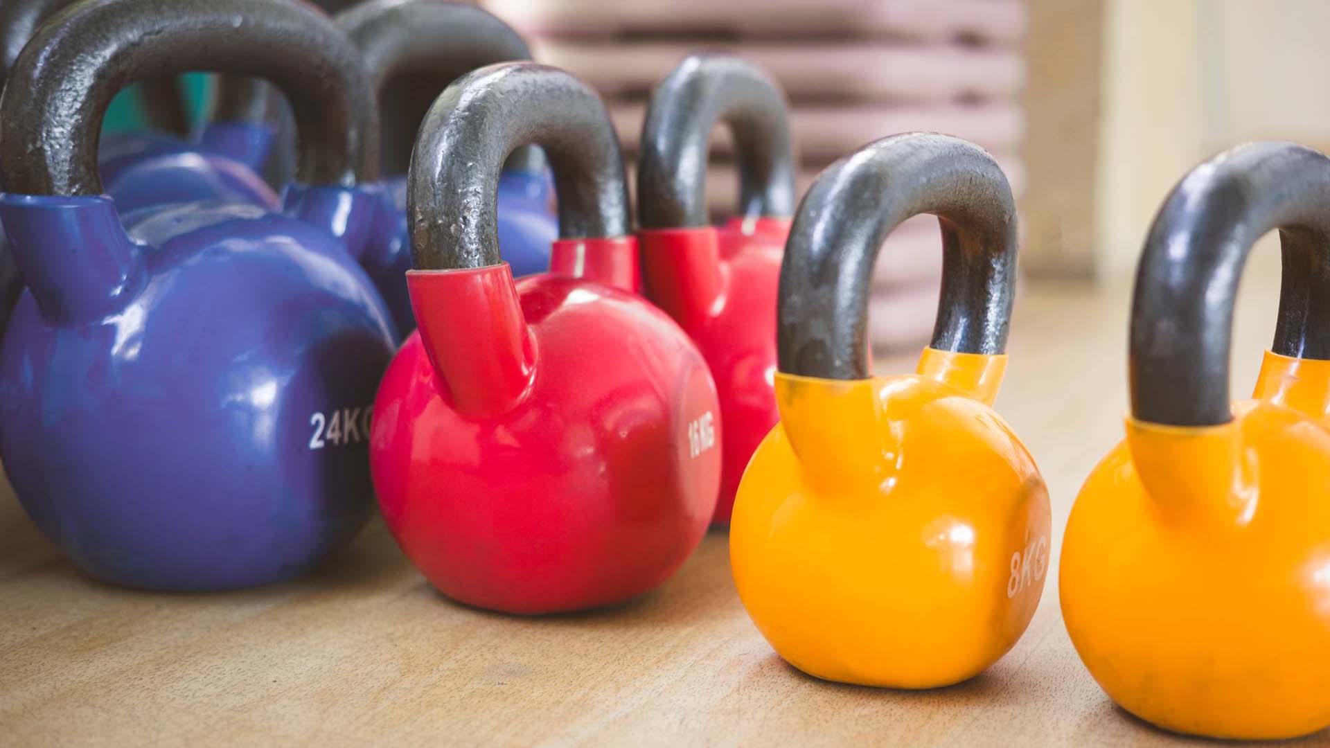 Blue , red and yellow kettlebells in varying weights