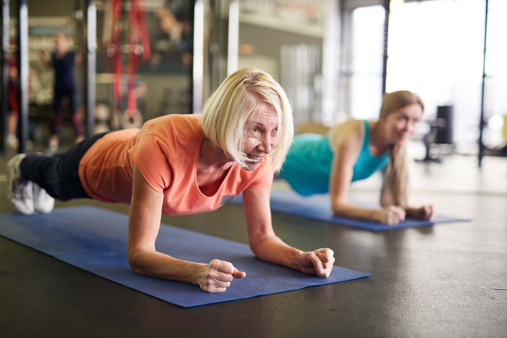 Two women doing the plank exercise