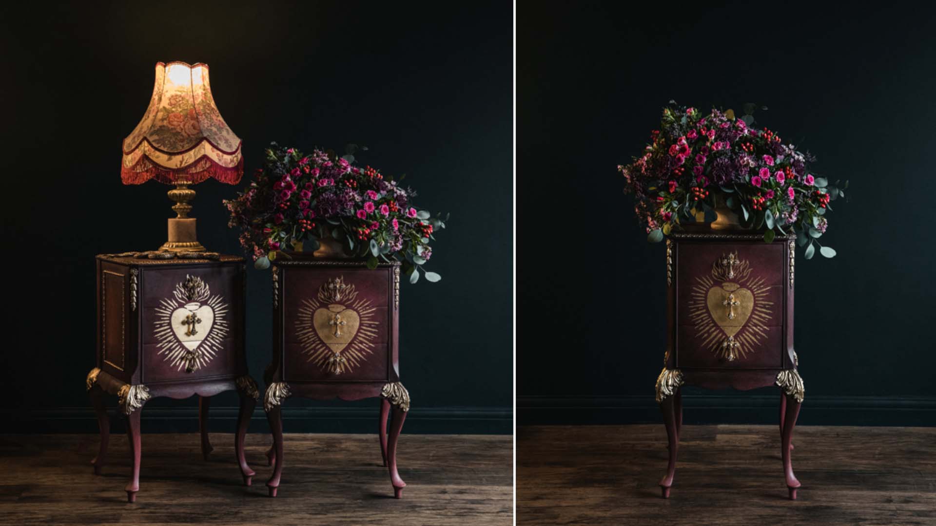 Bedside tables painted in a dark maroon colour with gold details against a dark wall with moody lamplight