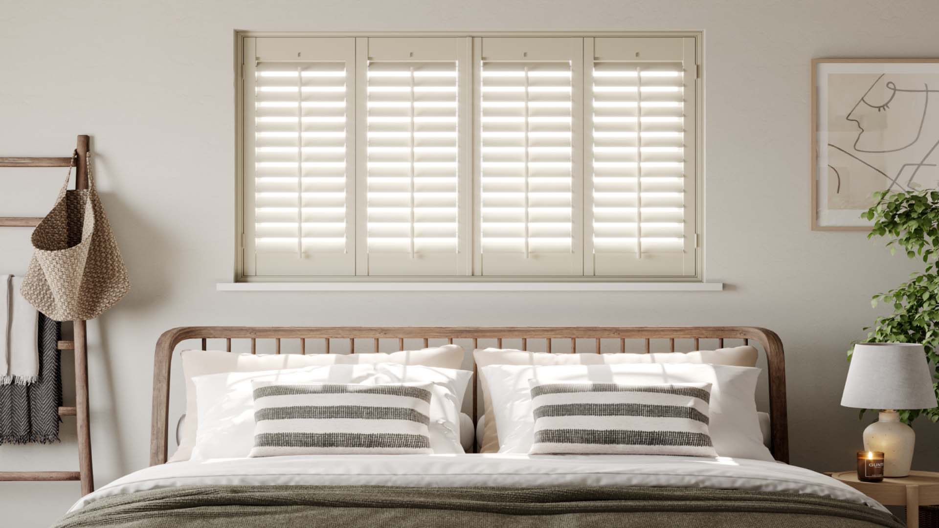 A window with fitted shutters above a double bed.