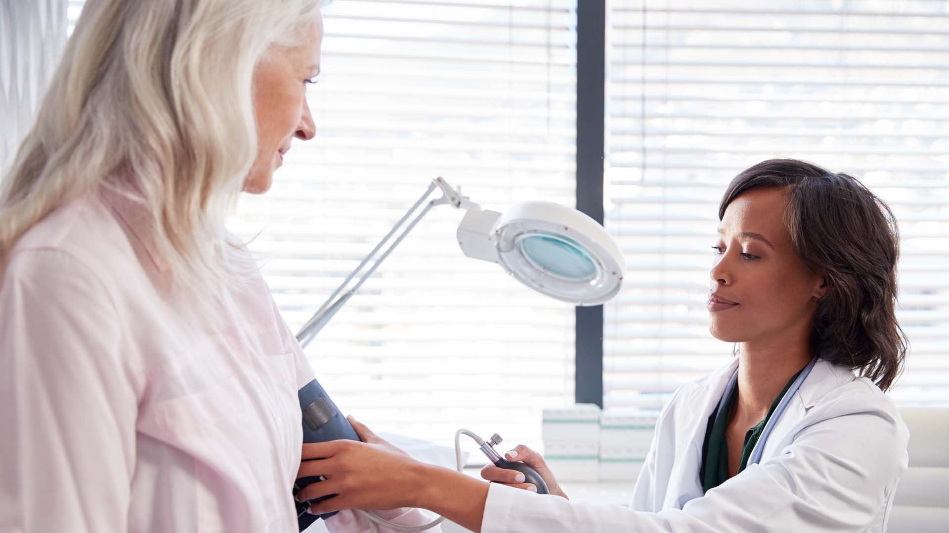 Patient getting blood pressure checked by doctor