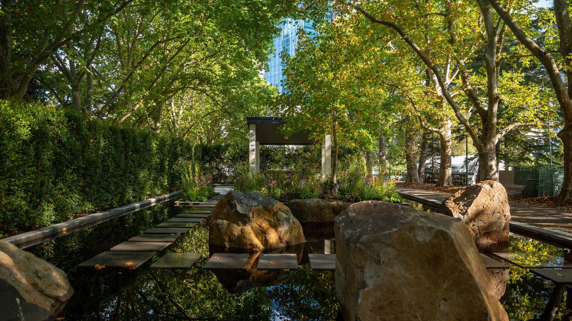 Shaded garden with water and trees