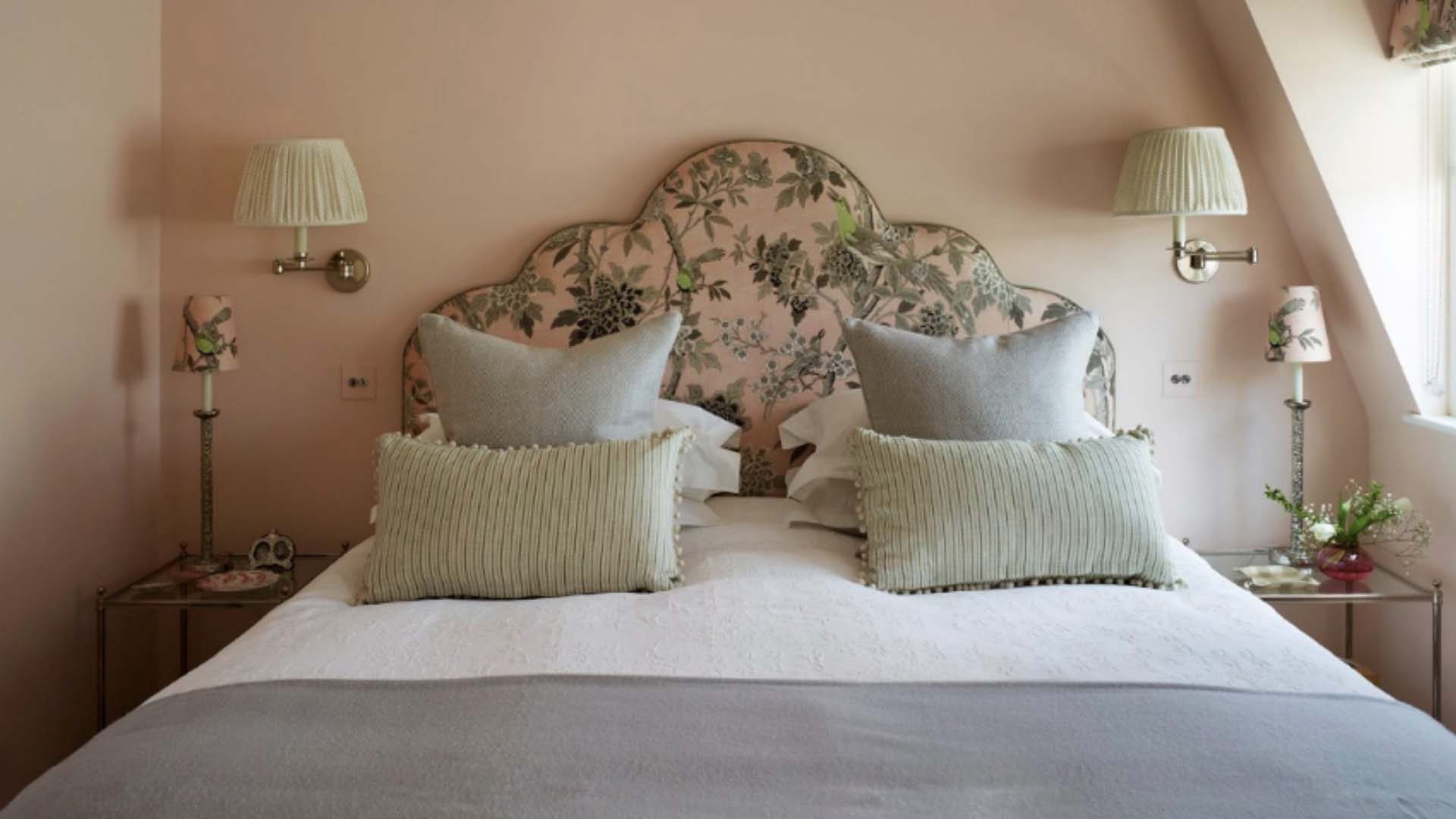 Pink headboard and double lighting above the bed
