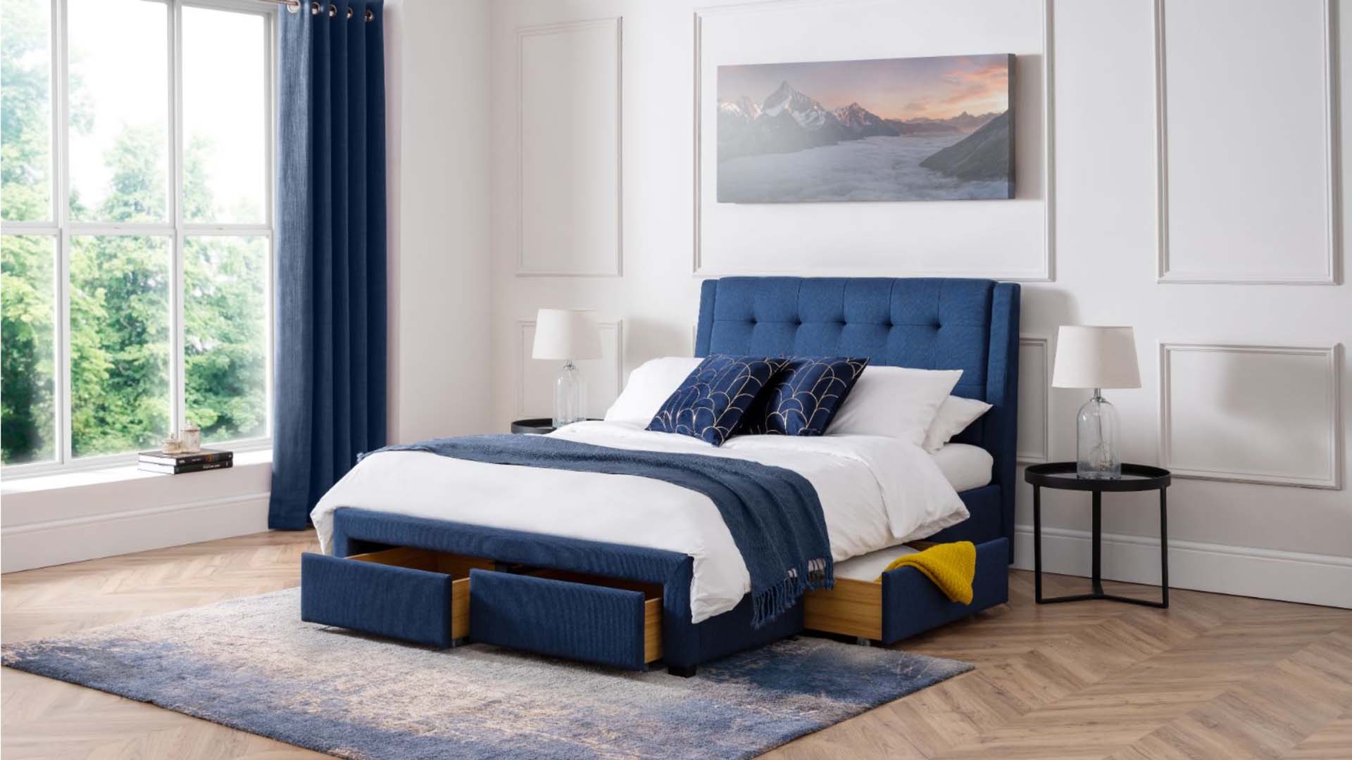 blue bed against pale grey panelling