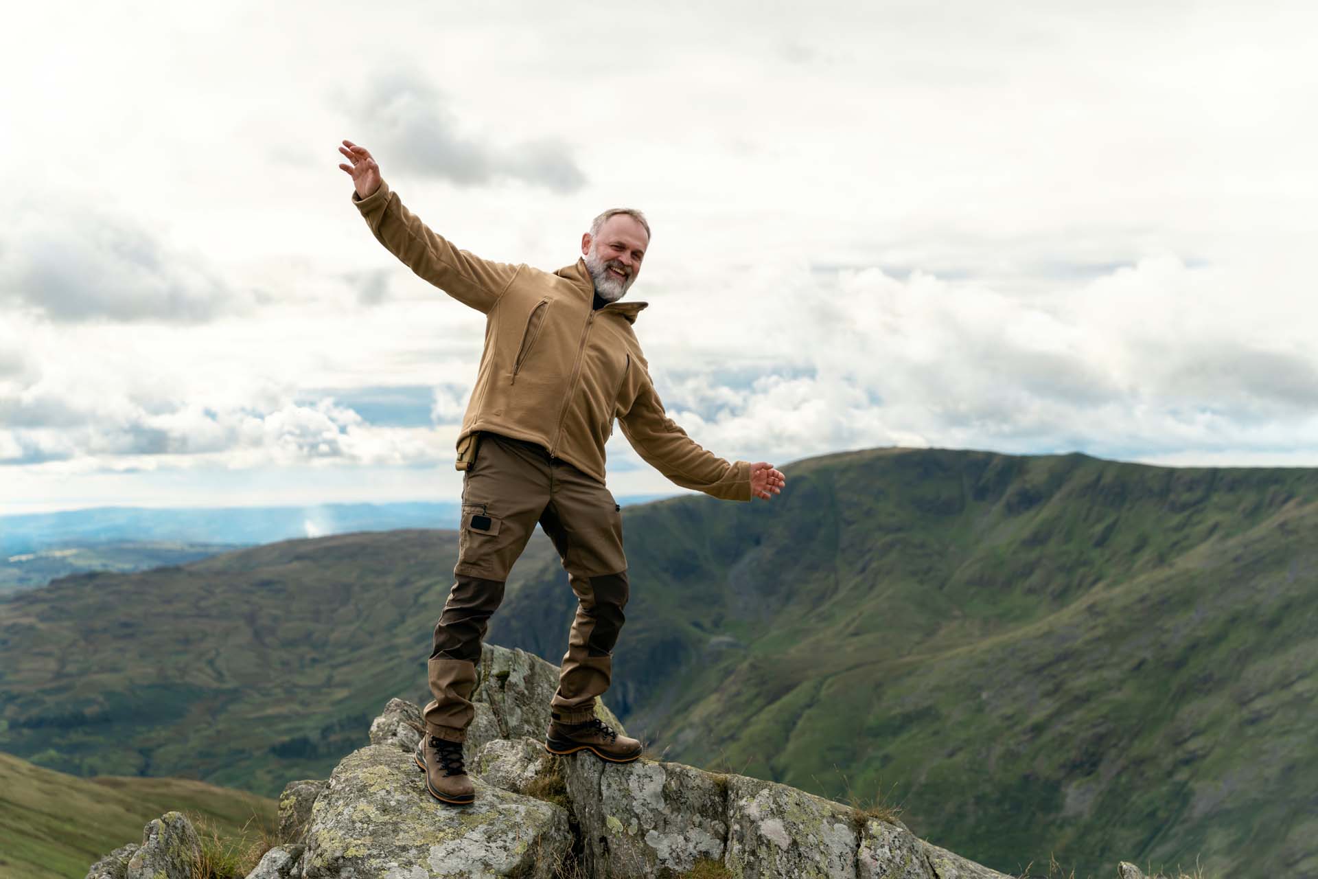 A hiker balancing on a rock
